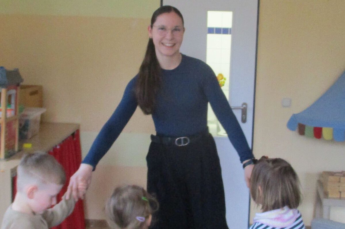 Anerkennungspraktikatin in der Kita Windischholzhausen beim Tanzen Anerkennunspraktikantin aus der Kita Windischholzhausen tanzt mit den Kindern im Reigen