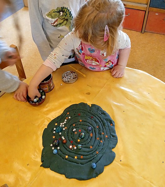 Kind knetet das Weltall
